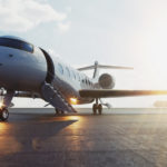 Business jet airplane parked at outside and waiting vip persons. Luxury tourism and business travel transportation concept. Flares. 3d rendering.